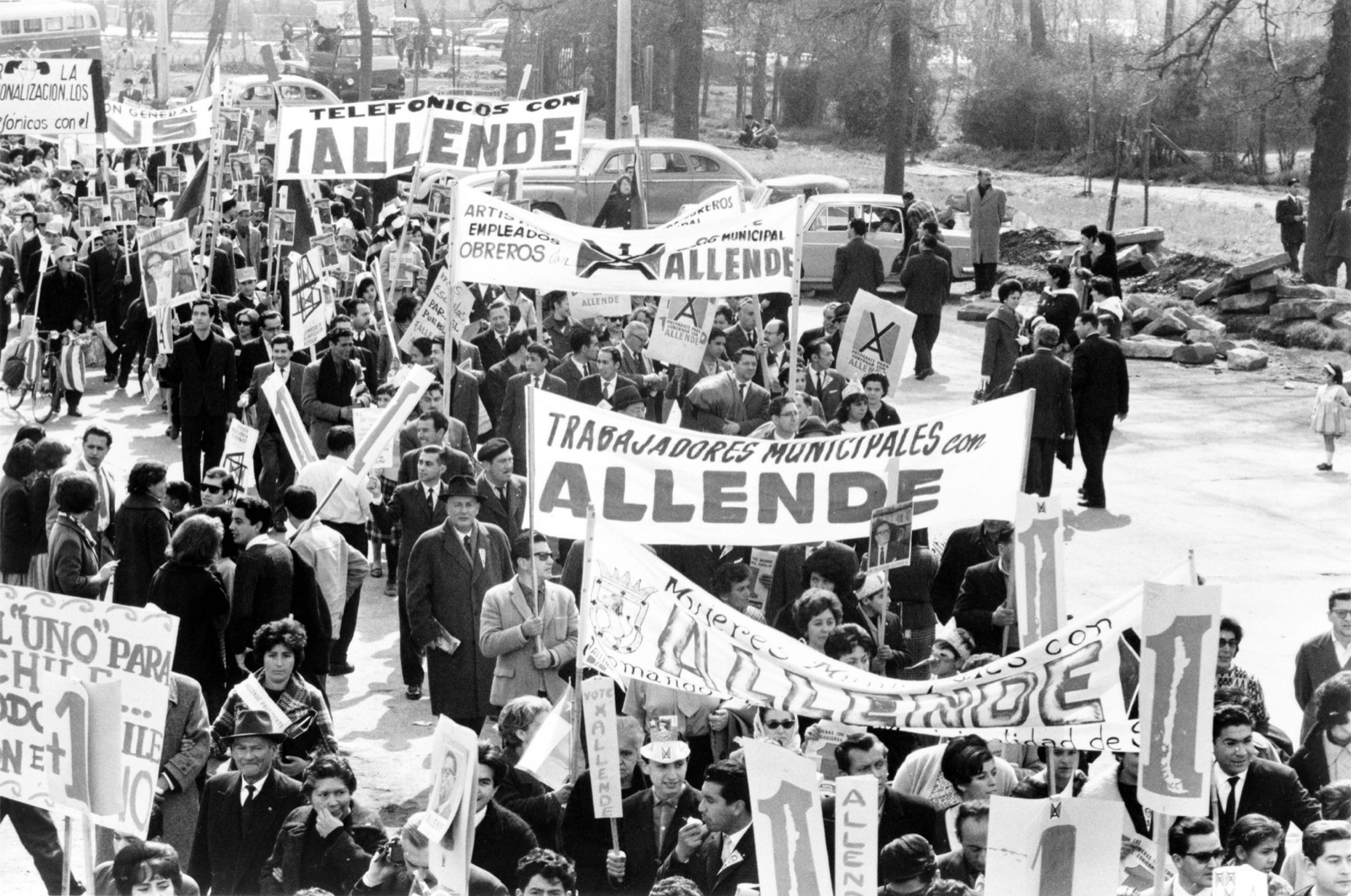 Supporters of Salvador Allende at a rally in Chile, circa 1970-1973. Crowd holding banners and Chilean flags.