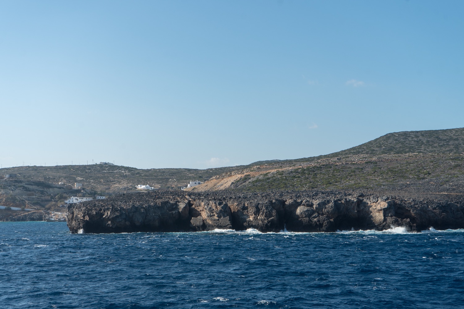 The rocky island of Antikythera rising from the sea, seen from a passing ferry.