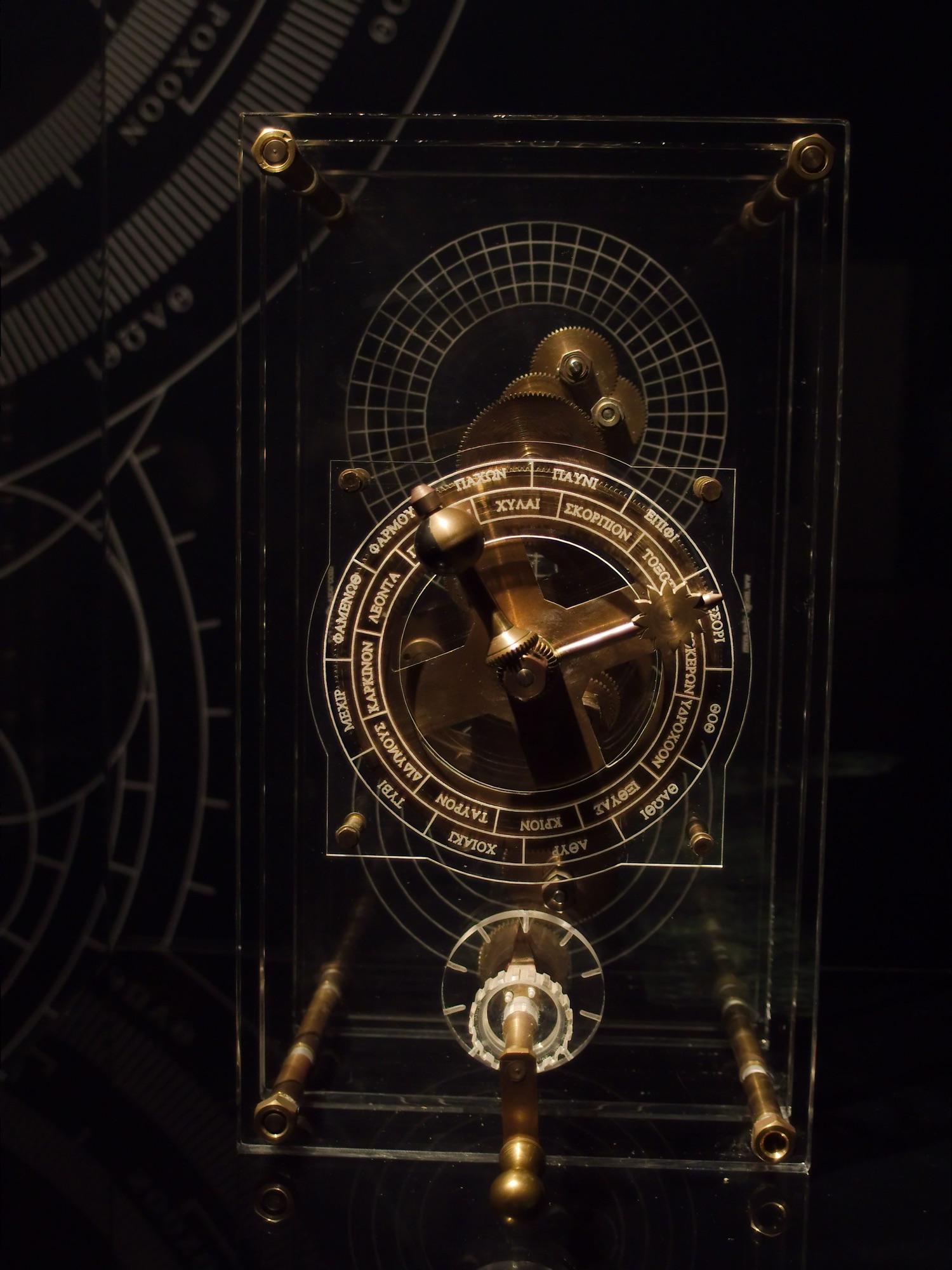 A modern reconstruction of the Antikythera Mechanism showing its bronze gears assembled in a frame.