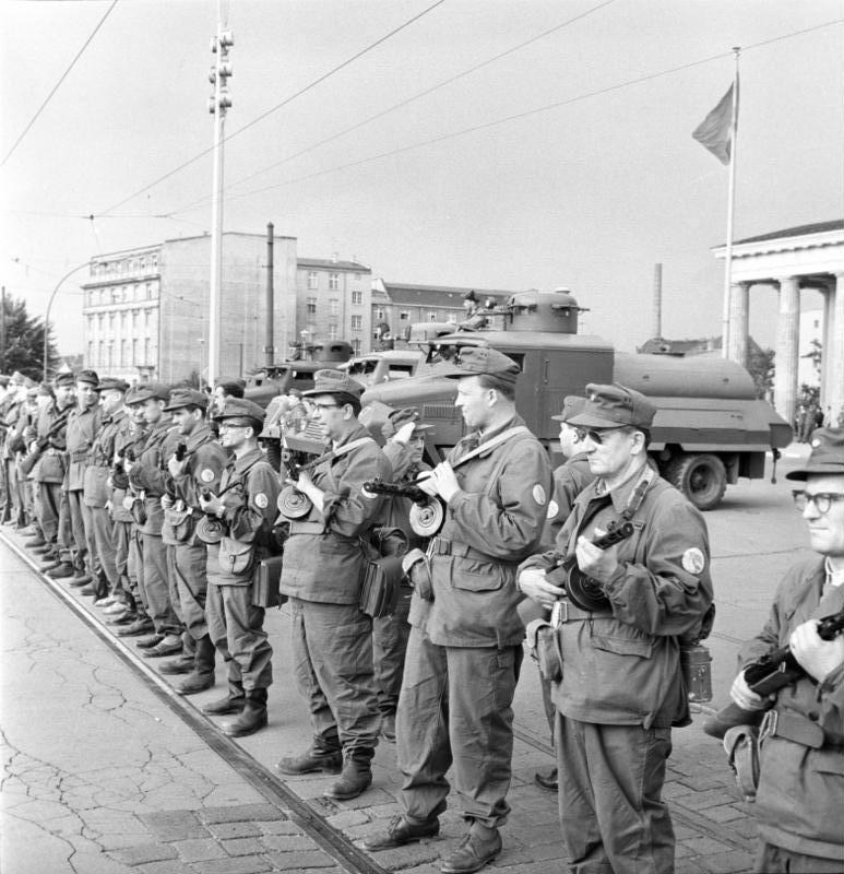 East German combat groups standing in formation at the Brandenburg Gate during the building of the Berlin Wall in 1961.