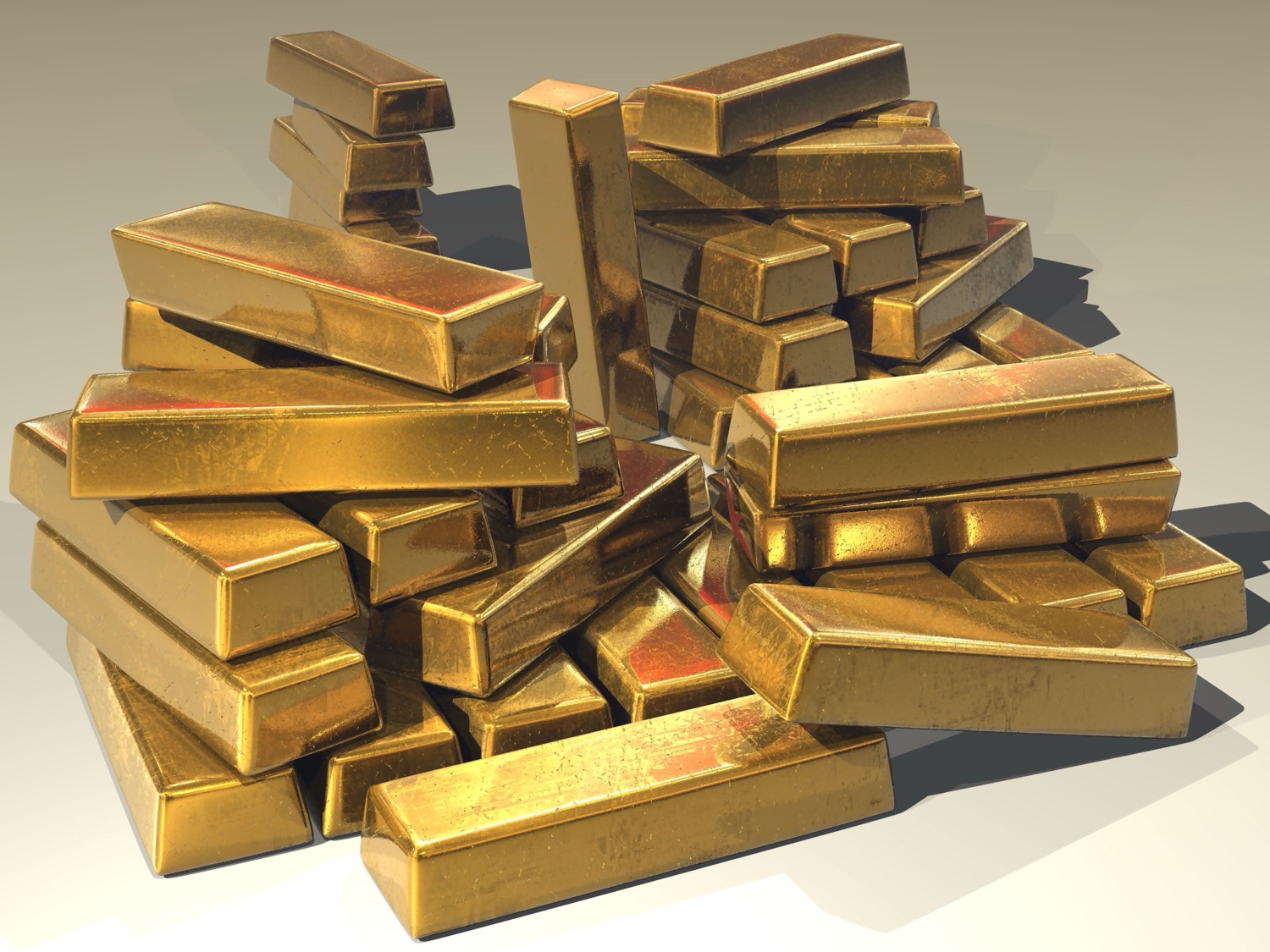 Stacked gold bullion bars, gleaming yellow, representing great wealth.