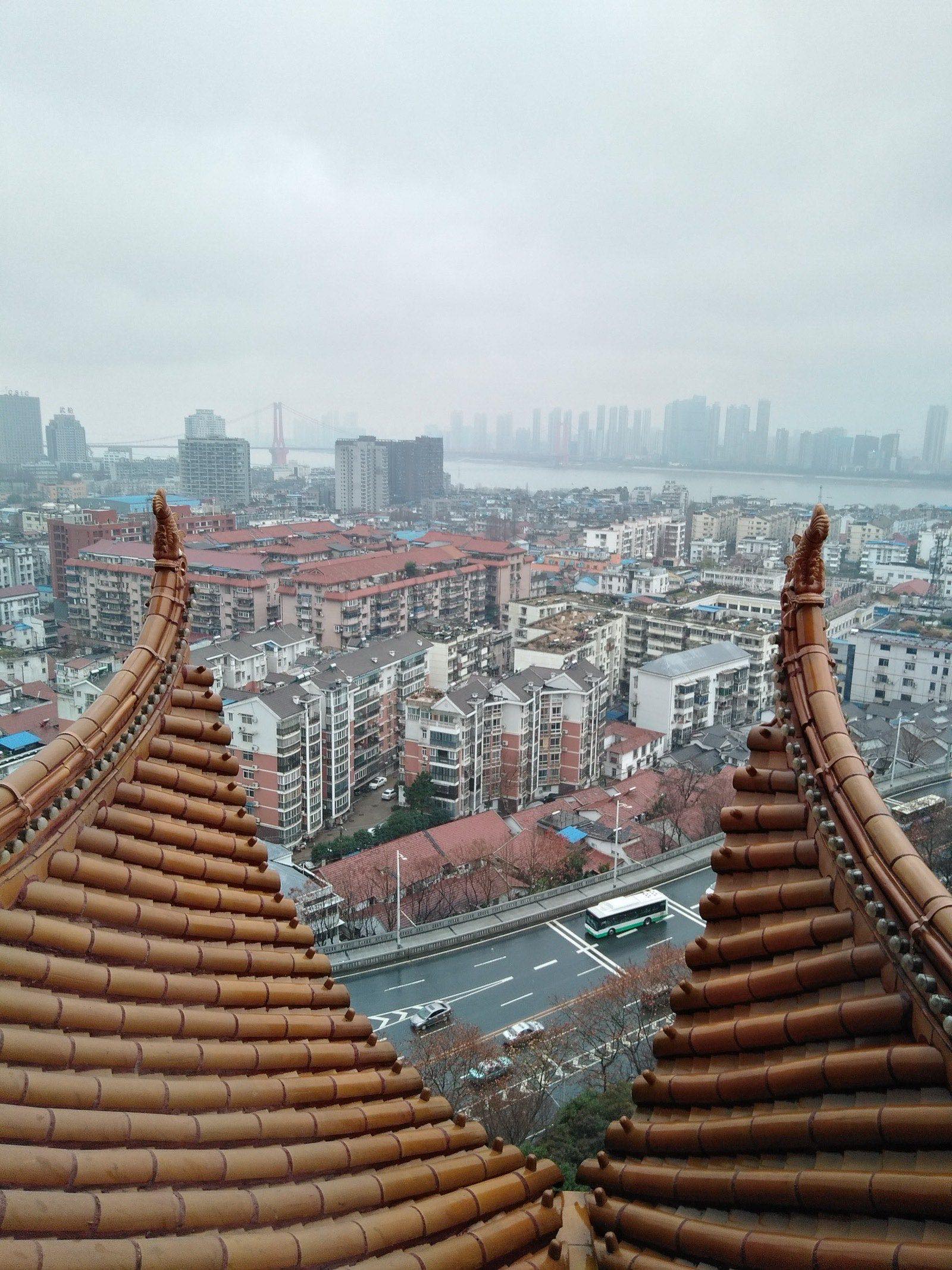 The Wuhan skyline along the Yangtze River, photographed in daylight — central Wuhan's modern high-rises against a clear sky.