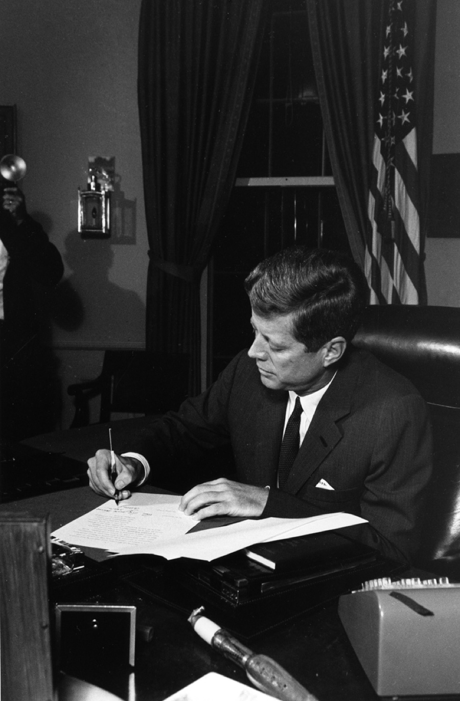 President Kennedy signing the proclamation authorizing the naval quarantine of Cuba, 23 October 1962.