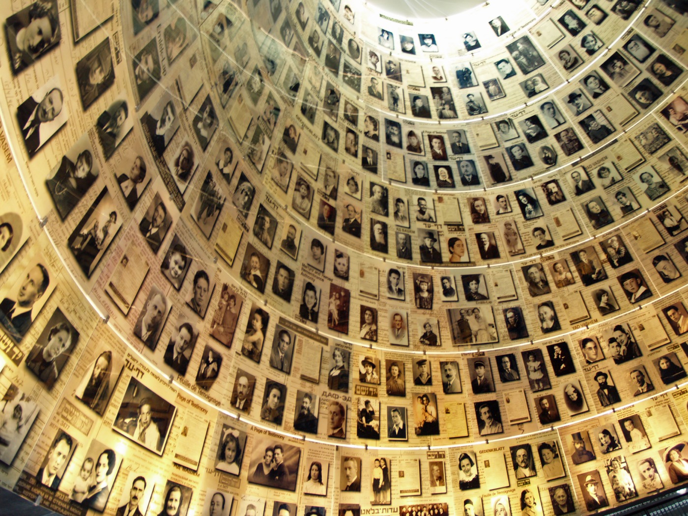 The Hall of Names at Yad Vashem, the Holocaust memorial in Jerusalem, with photographs of victims arranged in a domed space.