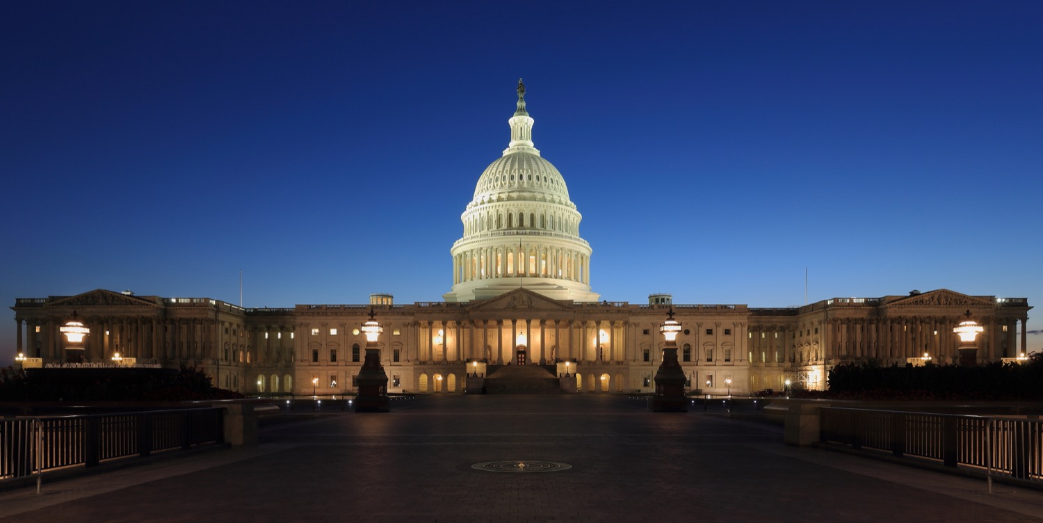 The United States Capitol building at dusk, illuminated against a darkening sky.