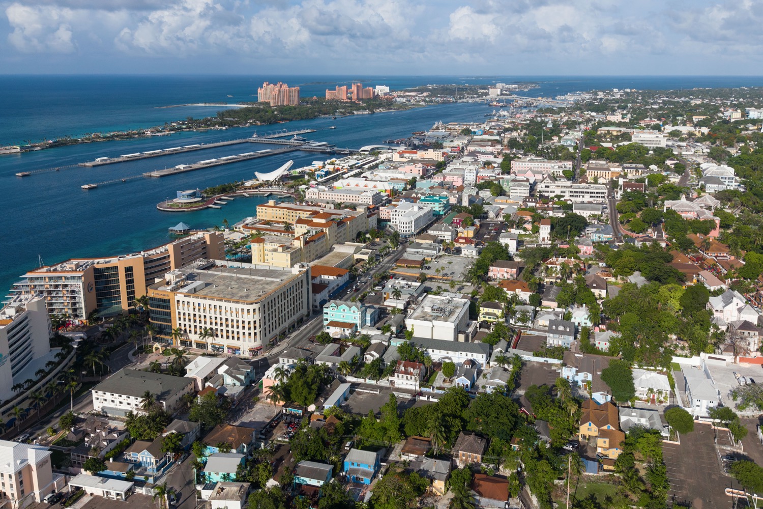 An aerial view of Nassau, the capital of the Bahamas, with turquoise water, islands, and city buildings.