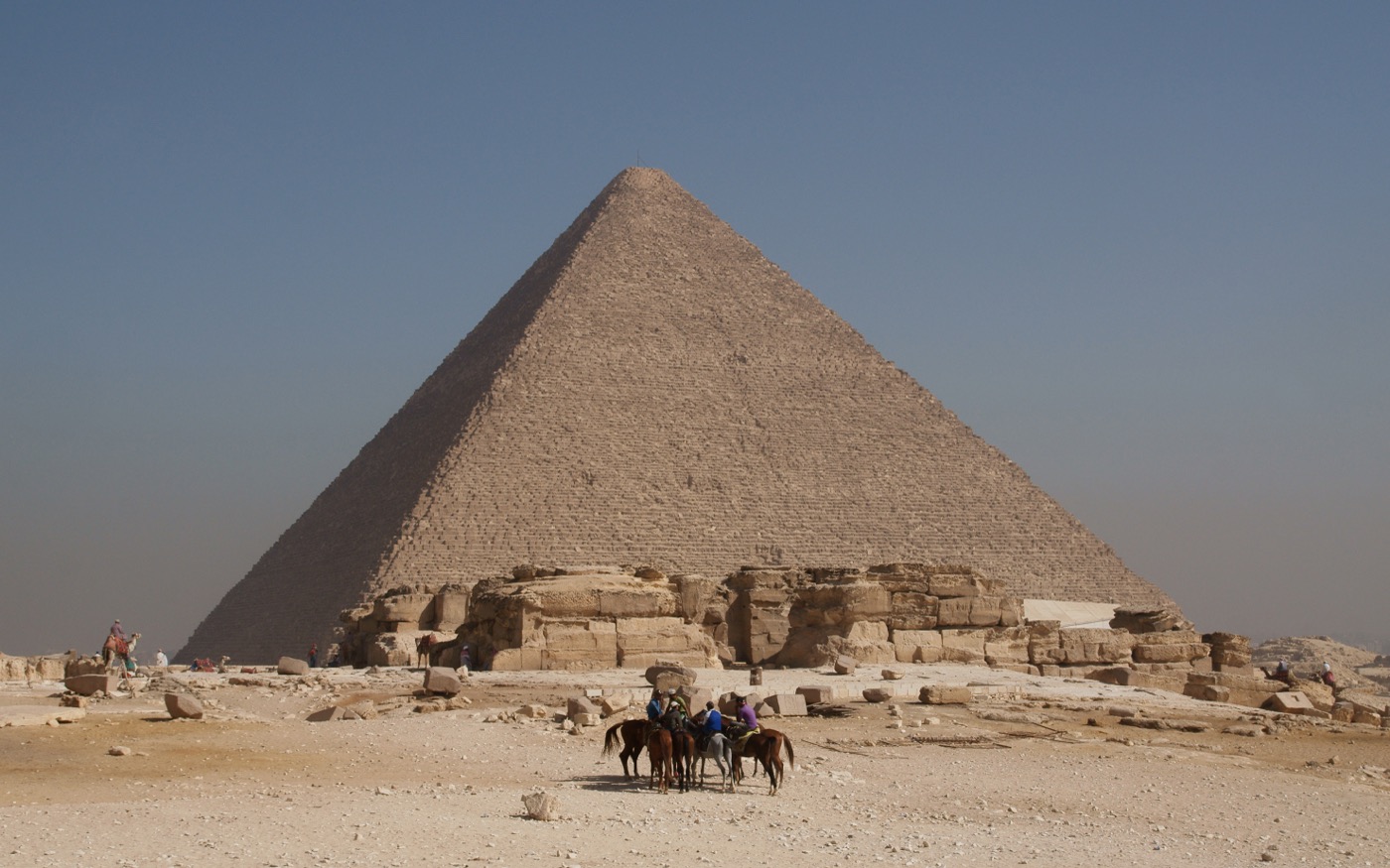 A view of the Great Pyramid's flank showing the massive stepped courses of limestone blocks up close.