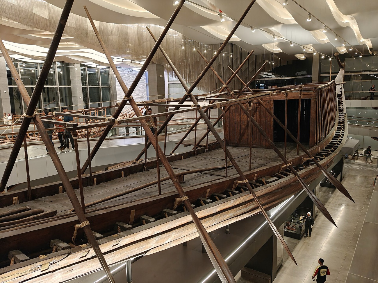 The reconstructed ancient wooden solar boat of Khufu on display in a museum.