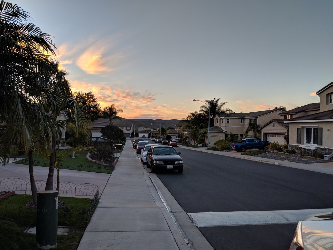 An ordinary California suburban neighborhood at sunset.