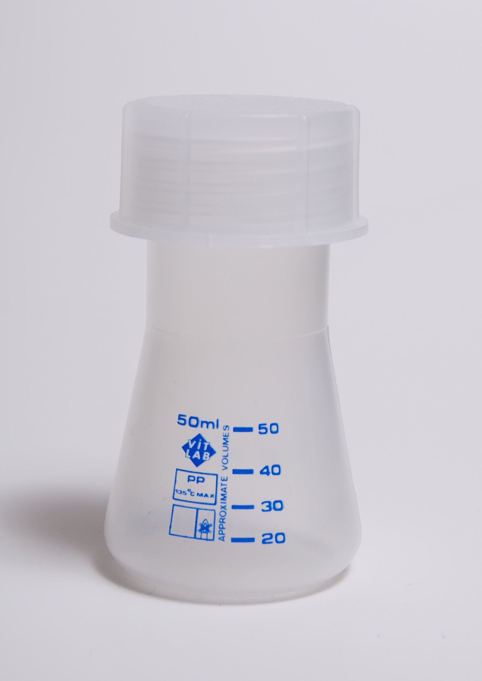 A clear plastic cell-culture flask containing pink-tinted growth medium, of the kind used to grow cells in a laboratory.