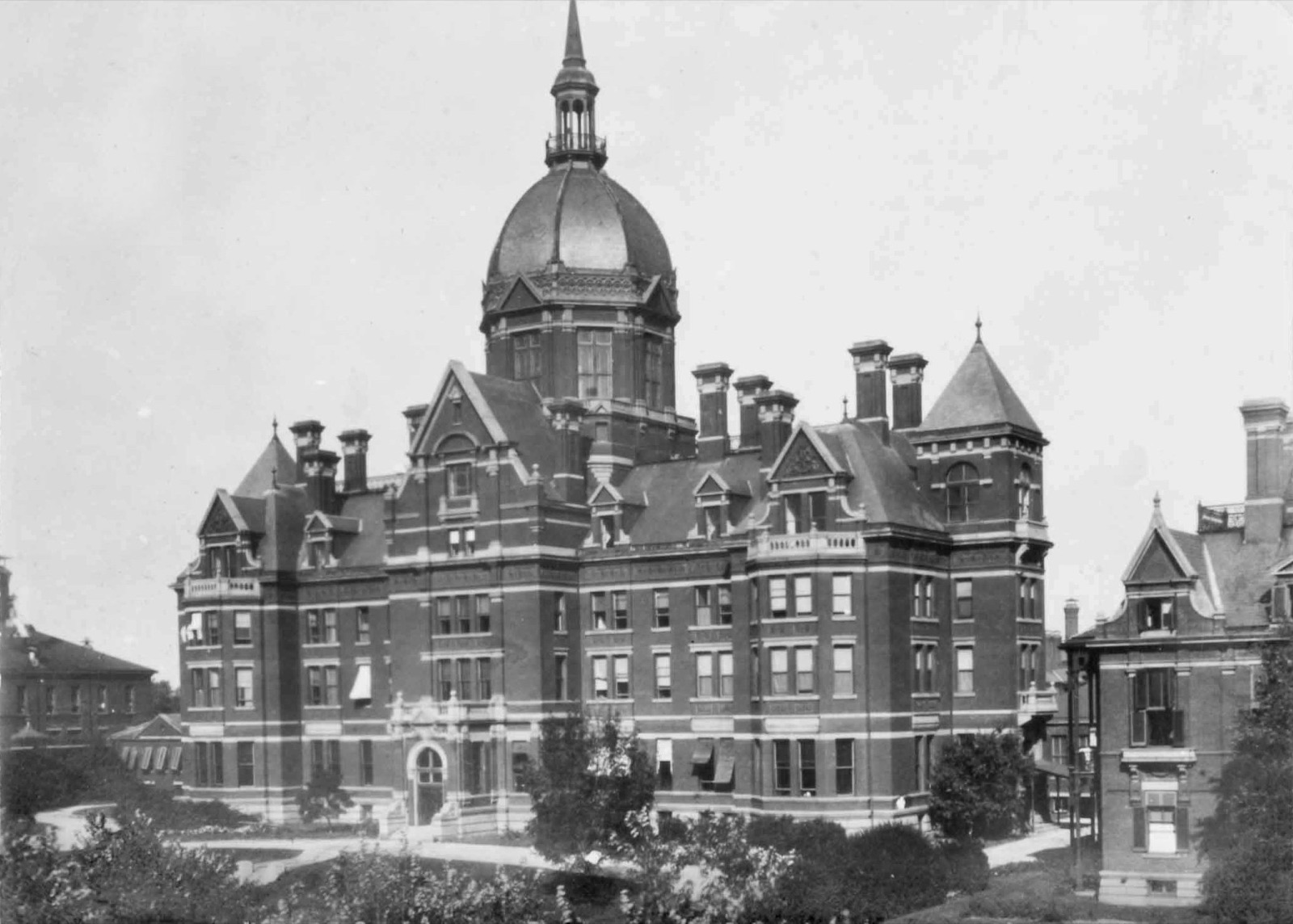 An early photograph of the Johns Hopkins Hospital in Baltimore: a large nineteenth-century brick building topped by a prominent domed administration block.
