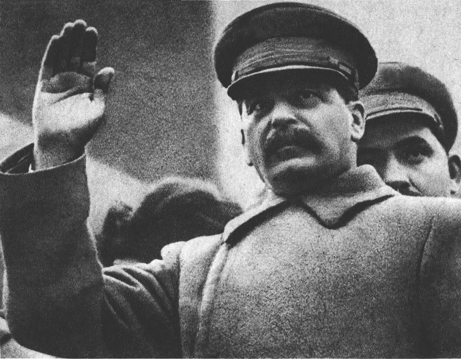 Joseph Stalin and Lazar Kaganovich photographed in 1933 — Stalin in his characteristic military tunic, Kaganovich in a darker civilian jacket, both wearing official Soviet bureaucratic dress.