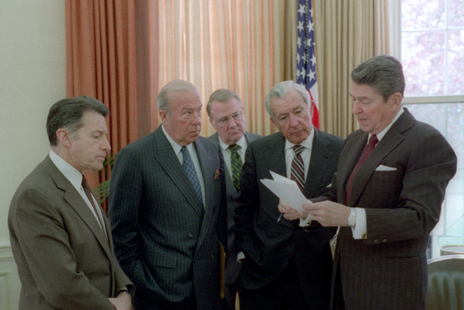 President Reagan meeting with senior advisors in the Oval Office during the Iran-Contra crisis.