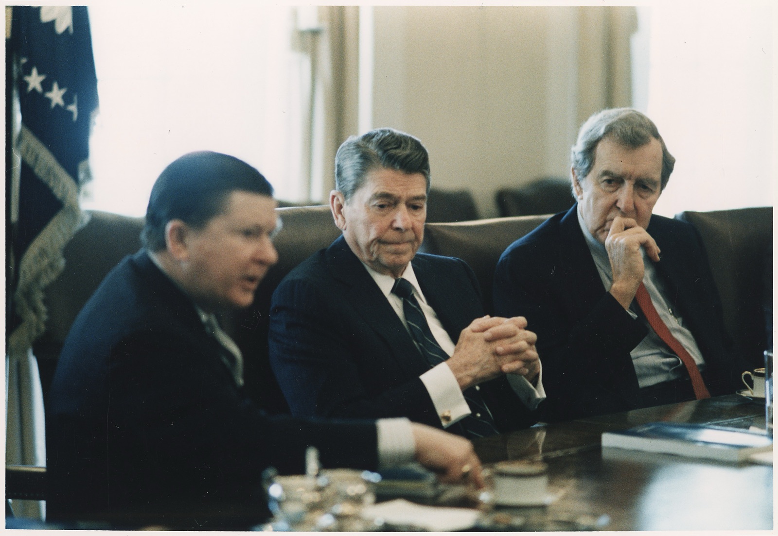 President Reagan receiving the Tower Commission Report from Senator John Tower and Senator Edmund Muskie.