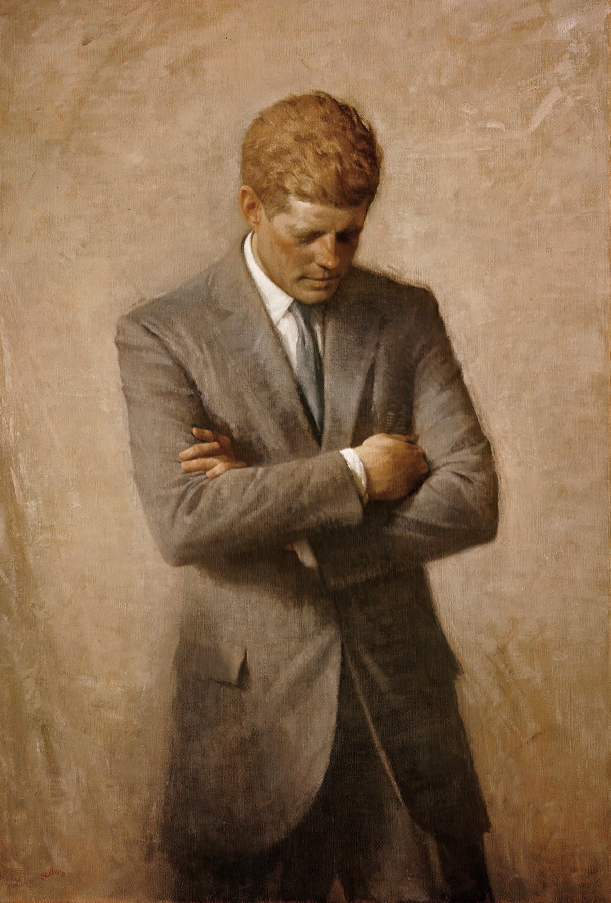 John F. Kennedy in his official White House portrait — wearing a dark suit and tie, looking slightly off-camera.