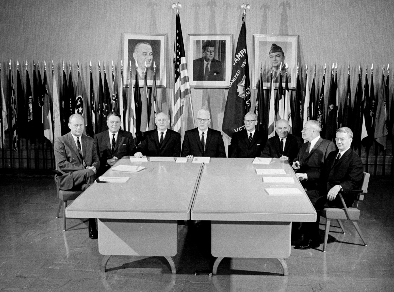 The seven members of the Warren Commission seated formally for a group photograph — distinguished older men in dark suits.