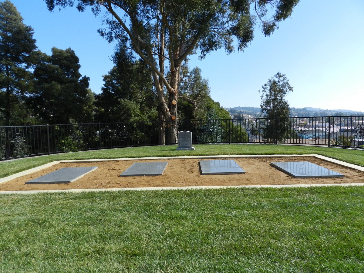 The Jonestown memorial at Evergreen Cemetery in Oakland, California, flat granite plaques set in the grass bearing the names of the victims.
