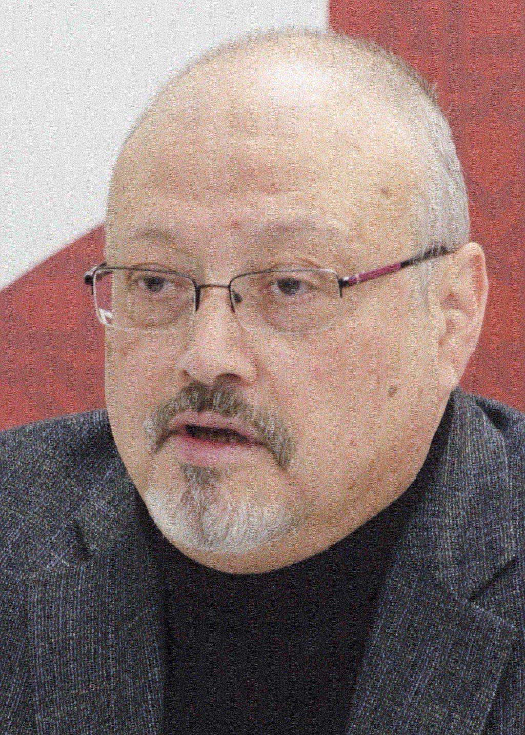 Jamal Khashoggi photographed in March 2018 — wearing a dark suit jacket and white shirt, looking past the camera.