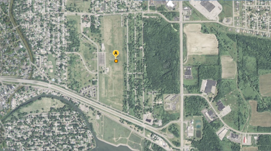 An aerial or satellite image of the Love Canal site showing the outline of the former canal amid the surrounding neighborhood.
