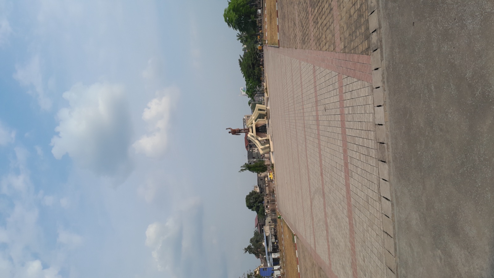 A bronze statue of Patrice Lumumba in Kinshasa, photographed against a clear sky.