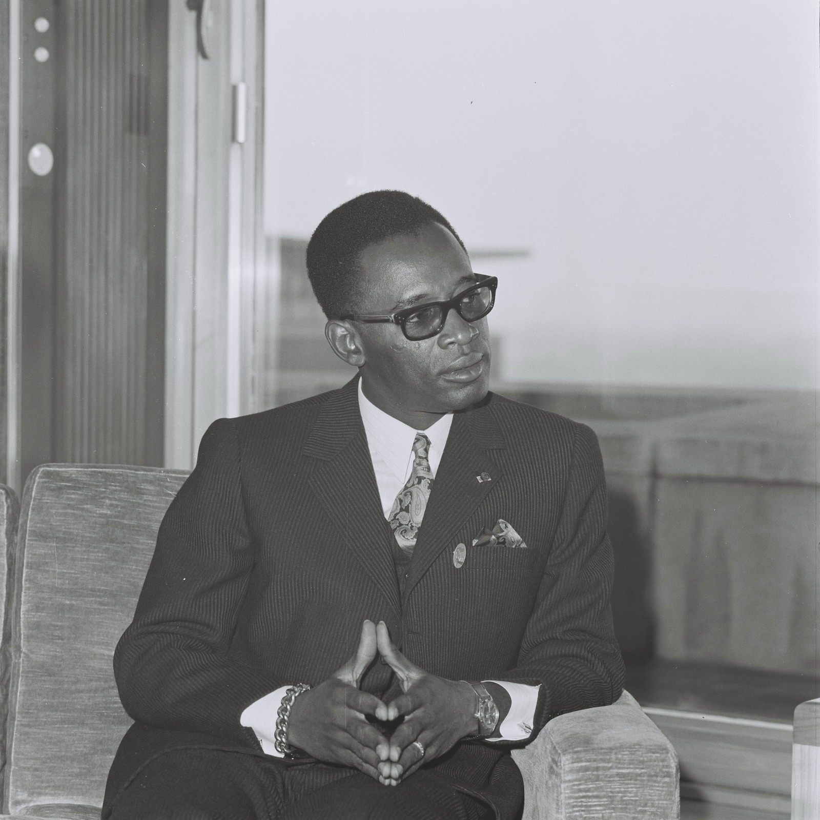 Mobutu Sese Seko photographed in 1969 — wearing his characteristic leopard-skin hat and dark uniform, with a serious expression.