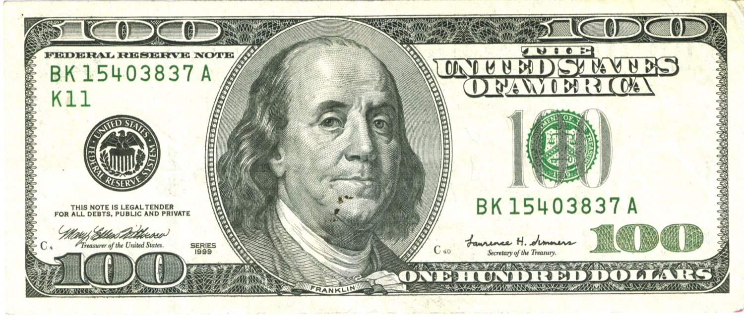 A United States one hundred dollar bill, showing the portrait of Benjamin Franklin.