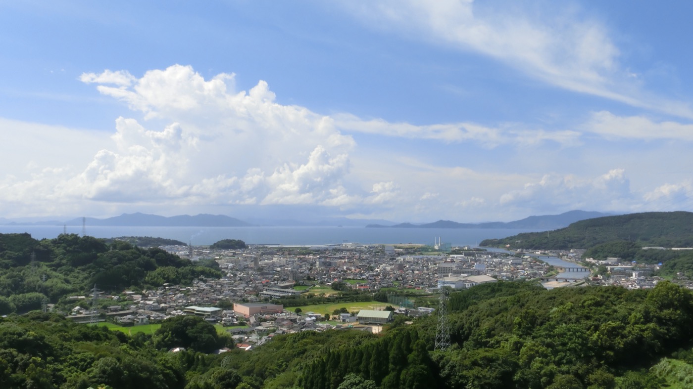 The town of Minamata in Kumamoto Prefecture, Japan, seen from a hillside above its bay.