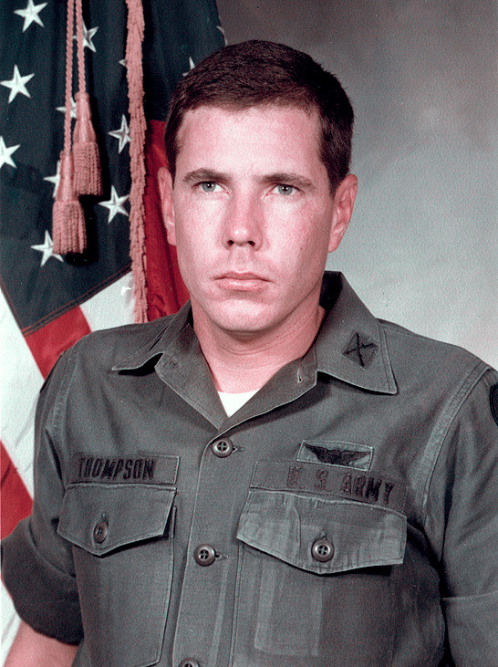 Warrant Officer Hugh Thompson Jr. in his official U.S. Army portrait — a young man in dress uniform with aviator wings on the chest, photographed in formal portrait pose against a neutral background.