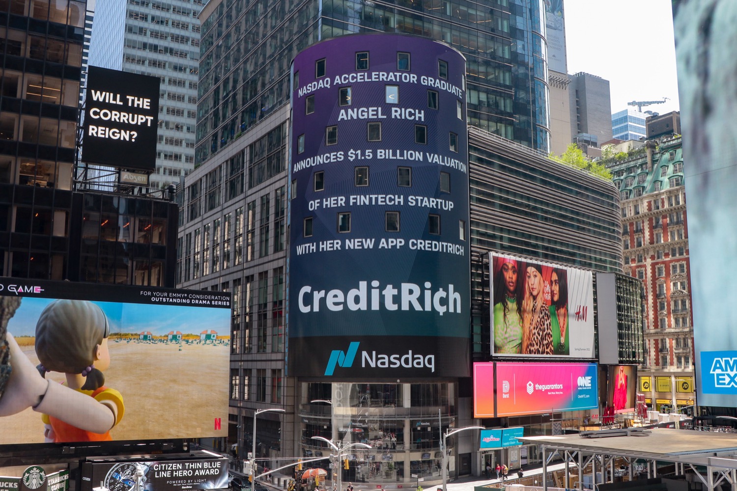 The Nasdaq MarketSite tower in Times Square, New York, a large curved digital display screen.