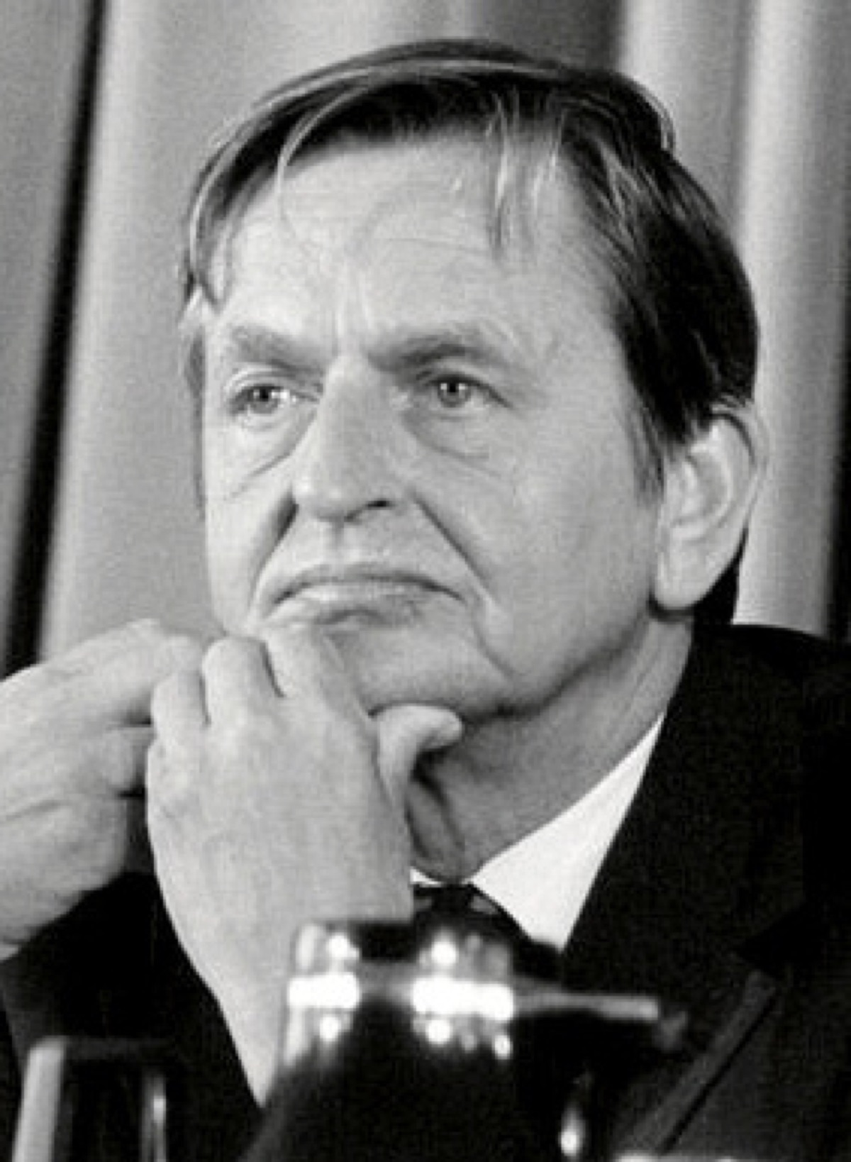 Olof Palme photographed circa 1984, in a dark suit and tie, looking off-camera.