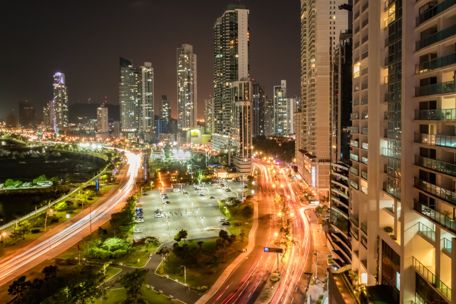 The skyline of Panama City — a dense cluster of modern glass office towers along the Pacific coast, photographed from across the bay.