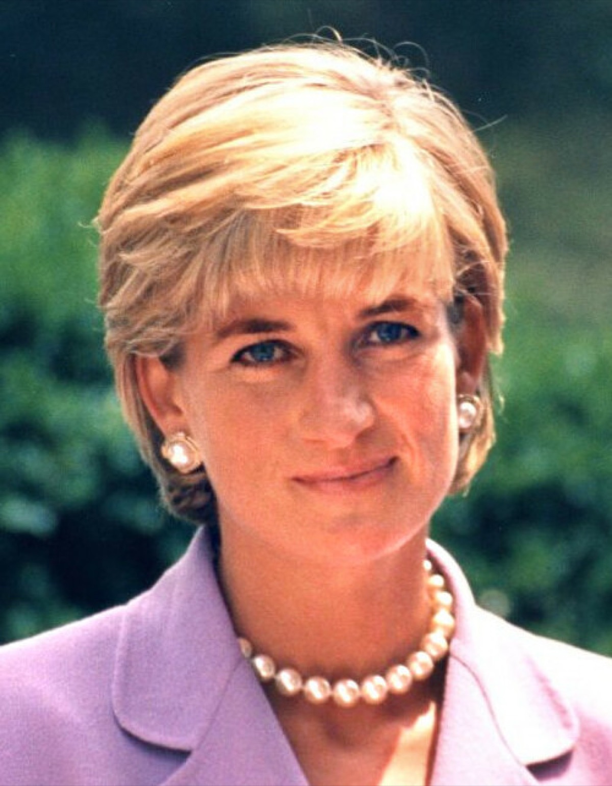 Diana, Princess of Wales photographed in 1997, in a pale top, looking off-camera.
