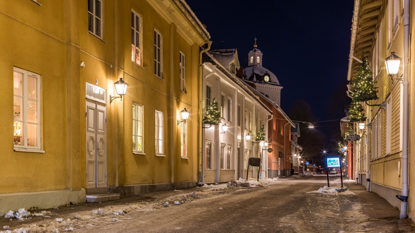 A quiet main street, Storgatan, in the small Swedish town of Säter, with low historic buildings and a dusting of snow.