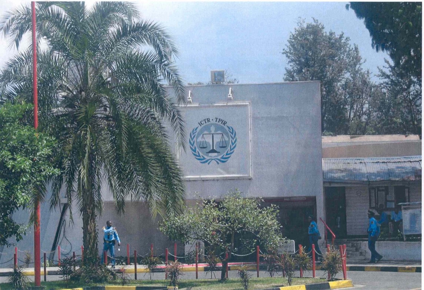 The building housing the International Criminal Tribunal for Rwanda in Arusha, Tanzania — a modern office and conference building behind a paved forecourt.