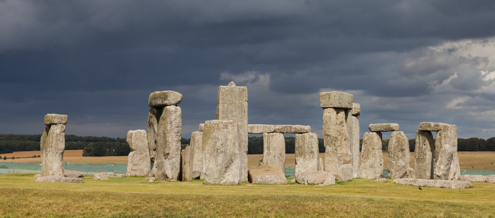 The stone circle of Stonehenge on Salisbury Plain, its great sarsen uprights and lintels standing against a wide sky.