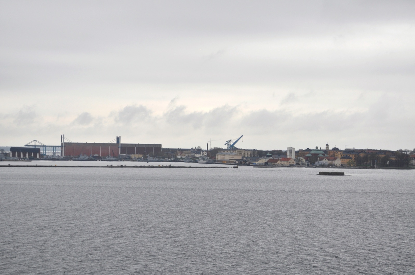 The Karlskrona naval base in southern Sweden, historic dockyard buildings and structures along the waterfront.