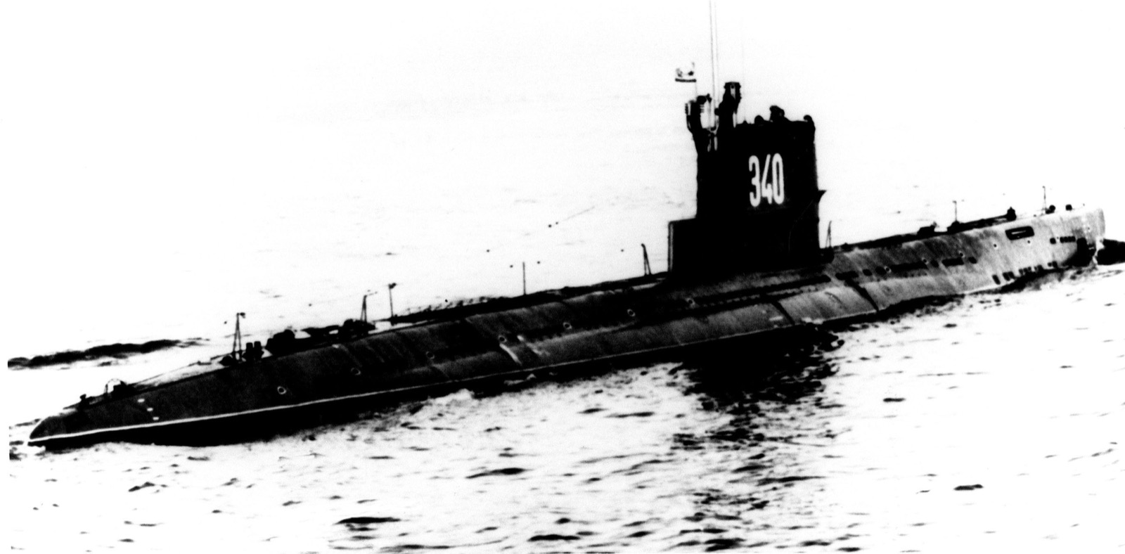 A Soviet Whiskey-class patrol submarine underway on the surface, a long low vessel with a tall conning tower.