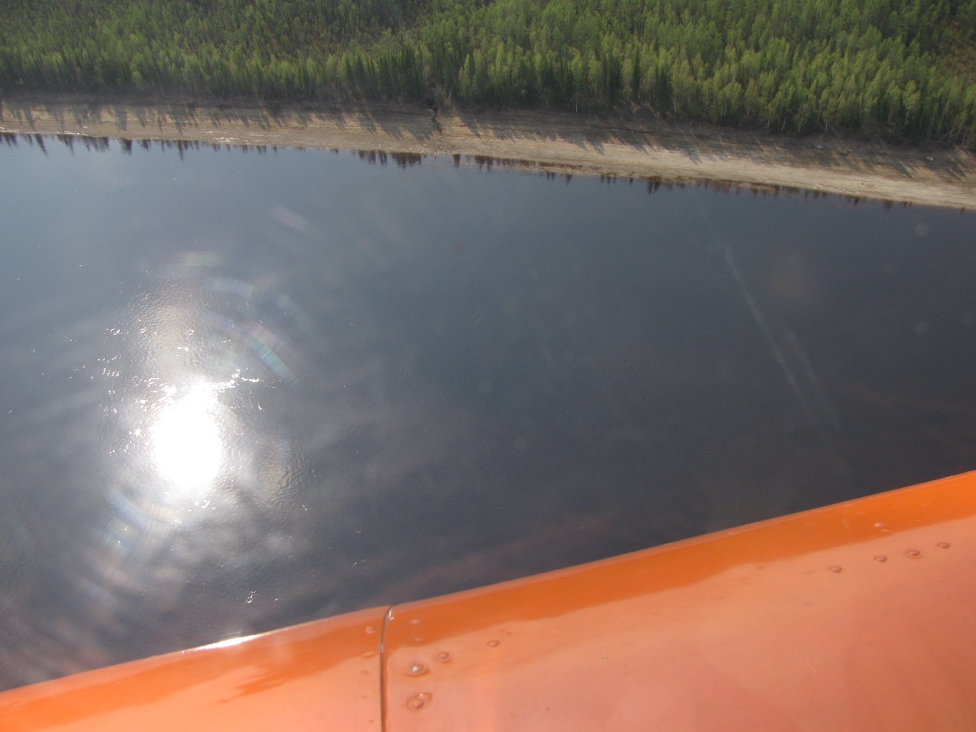 An aerial view of the Podkamennaya Tunguska River winding through the remote Siberian forest.