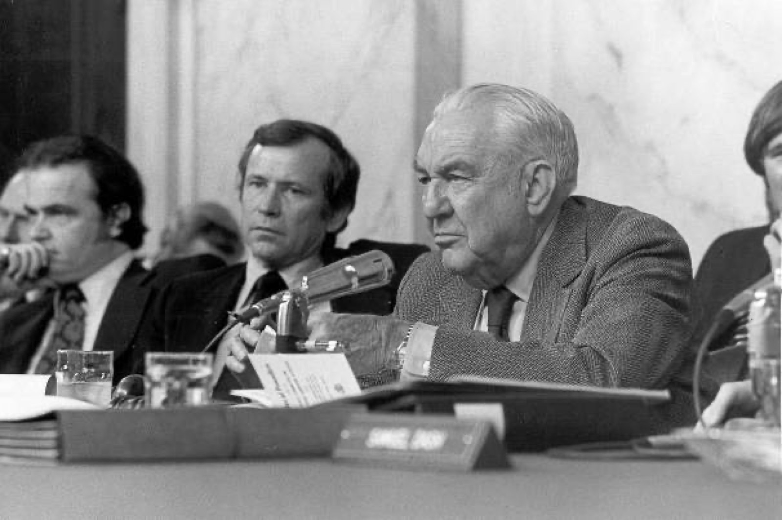Sam Ervin, Howard Baker, and Fred Thompson seated at the Senate Watergate Committee dais.