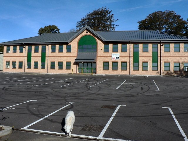 A commercial 'office space to let or for sale' sign on the side of a building, advertising empty premises.